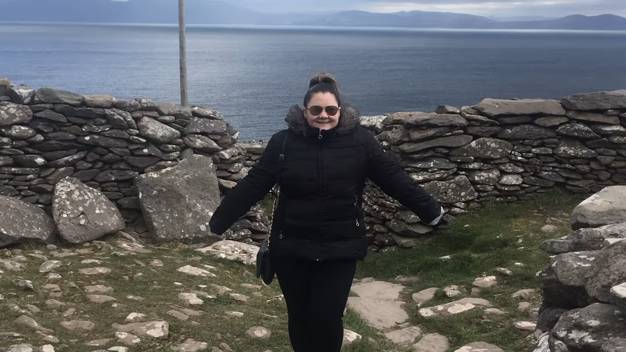 A picture of Kayley Conti standing amongst the ruins of a once-great society.