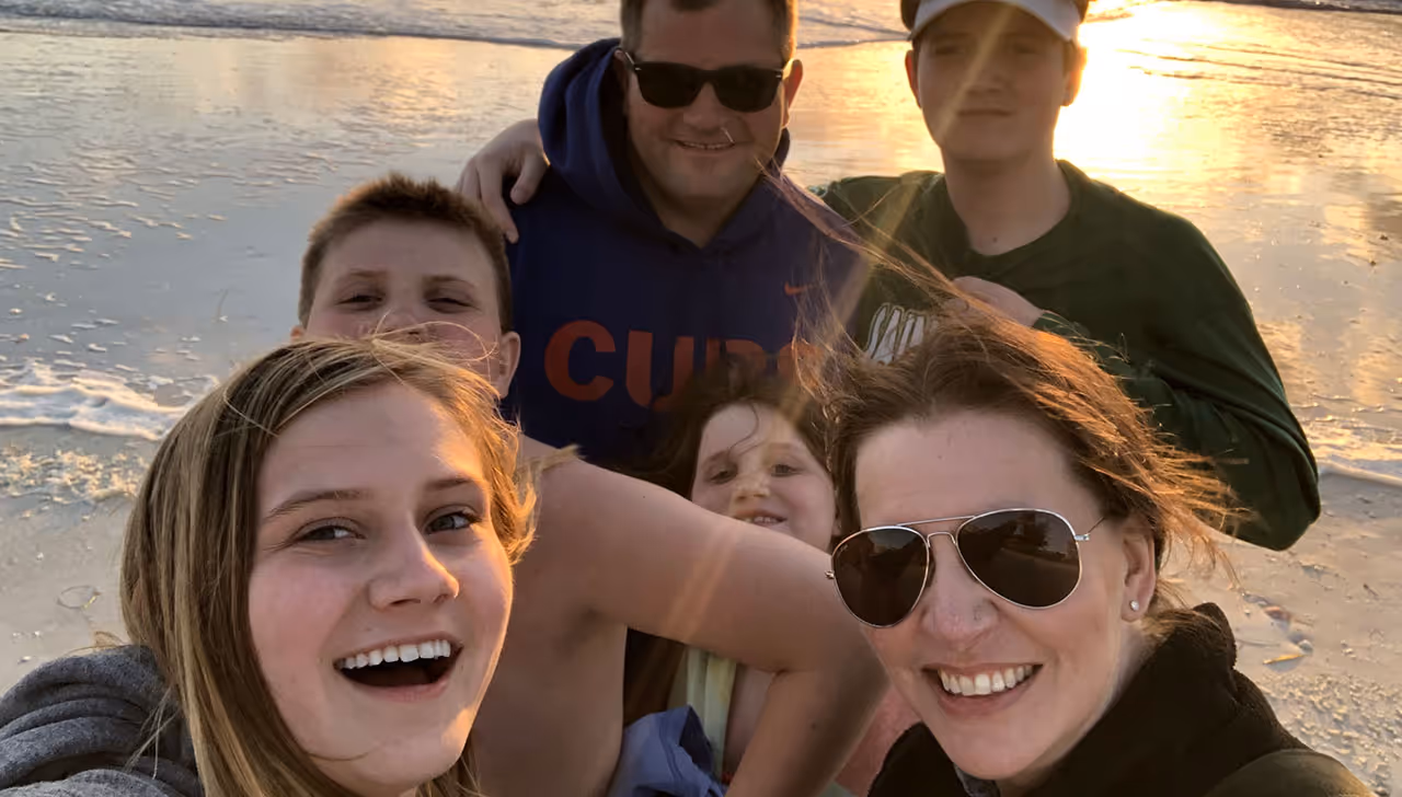 A photograph of Michelle Arnold and her family on a boat.