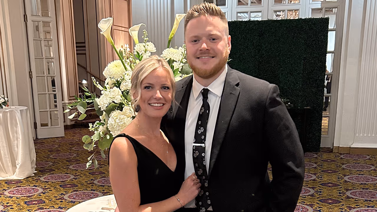 A photo of Leah Collette and her husband at a formal event