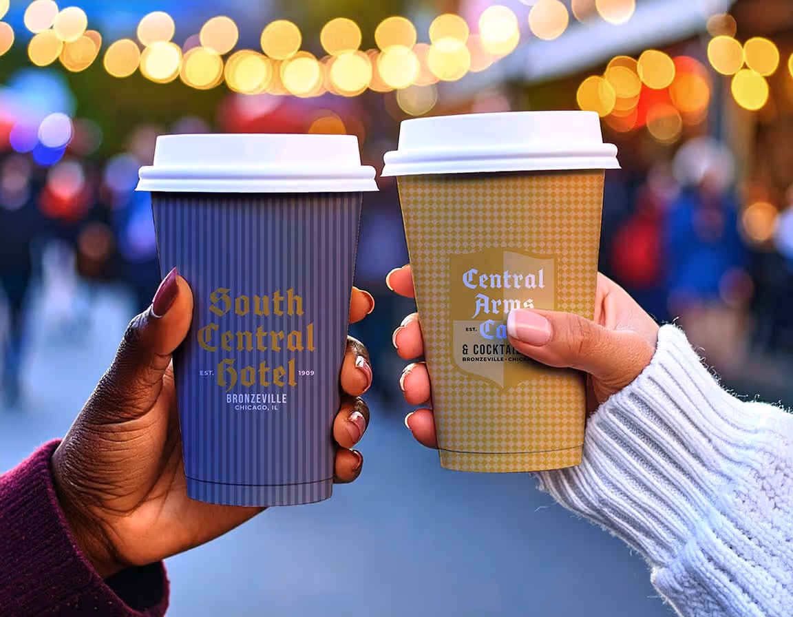 Firefly: A tight depth of field focuses on two white 12oz paper coffee cups being clinked together.