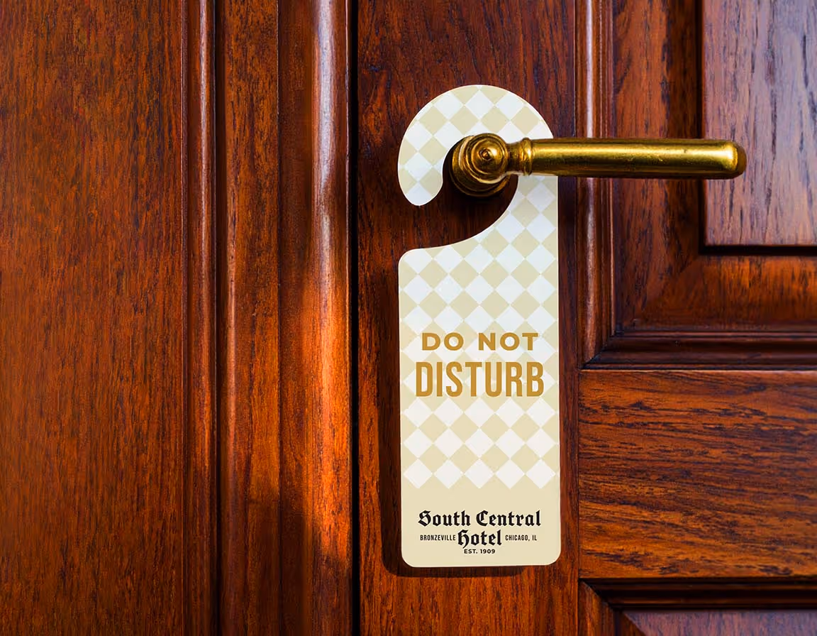Firefly: A clean, centered frame captures an antique paneled mahogany wood door with toupe and cream checkered door sign