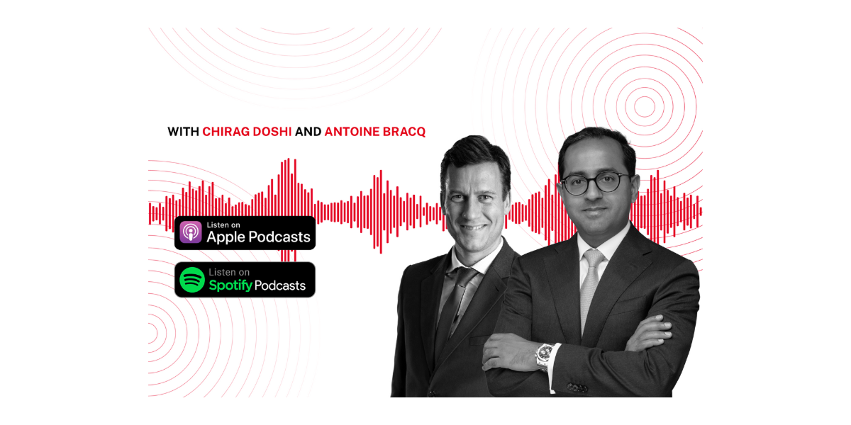 Chirag Doshi and Antoine Bracq stand in a meeting, smiling at the camera.