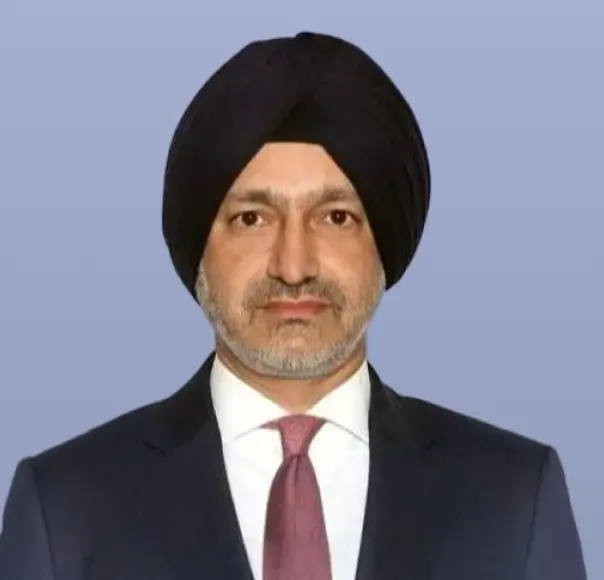 Amrit Singh, a man in a dark suit and tie, is shown in a headshot.