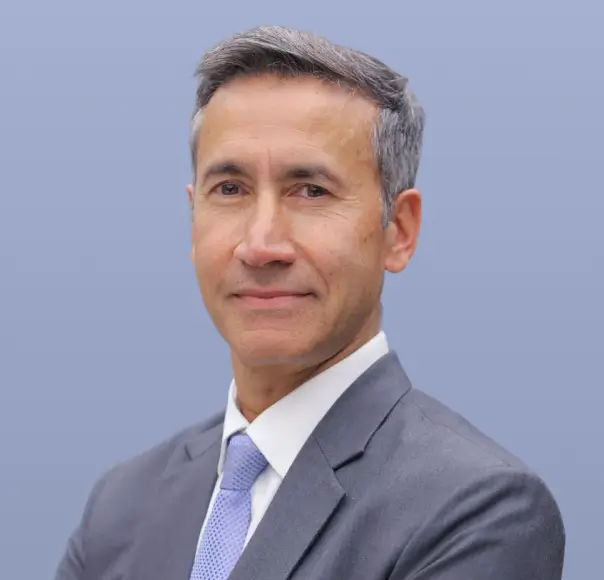 Gurjeet Sohi, a man with grey hair and a dark suit, is pictured.