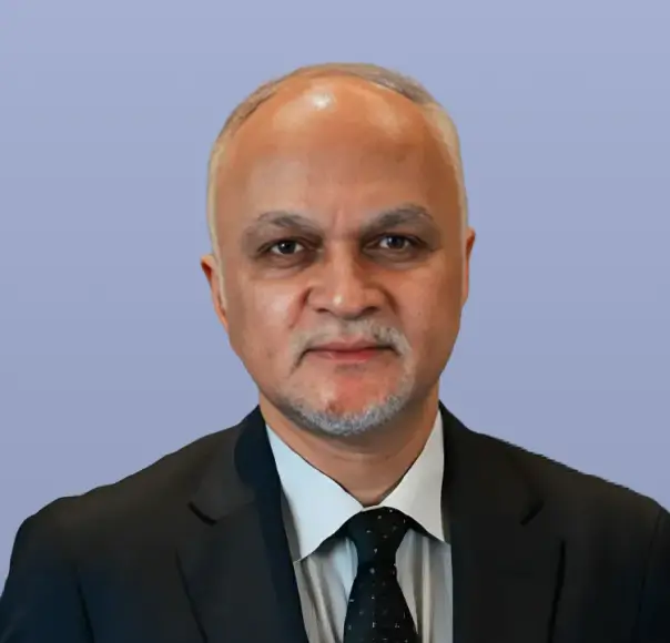 Balaji Prasanna, a man with grey hair and a dark suit.