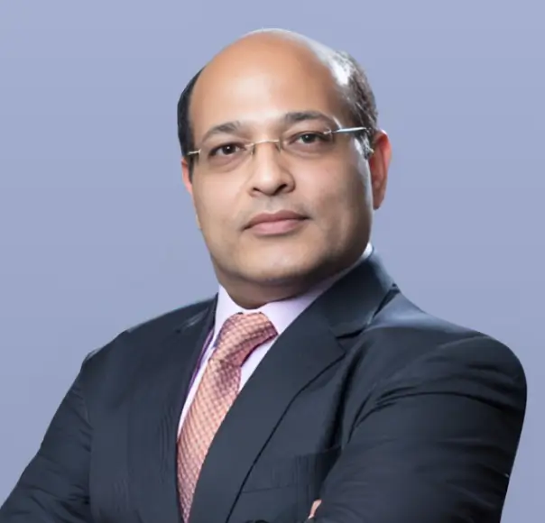 Prashant Tandon, a man in a dark suit and tie, is shown in a headshot.