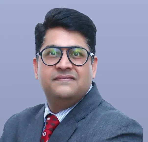 Sumegh Bhatia, a man in a dark suit and tie, is pictured.