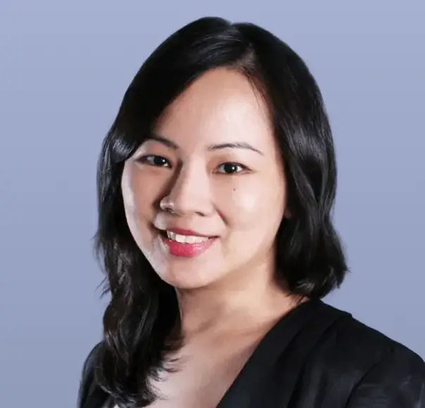 Tang Kar Wai Audrey, smiling, in a dark suit.