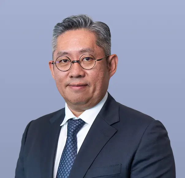 Won-Ki Kim, a man in a dark suit, wearing glasses.