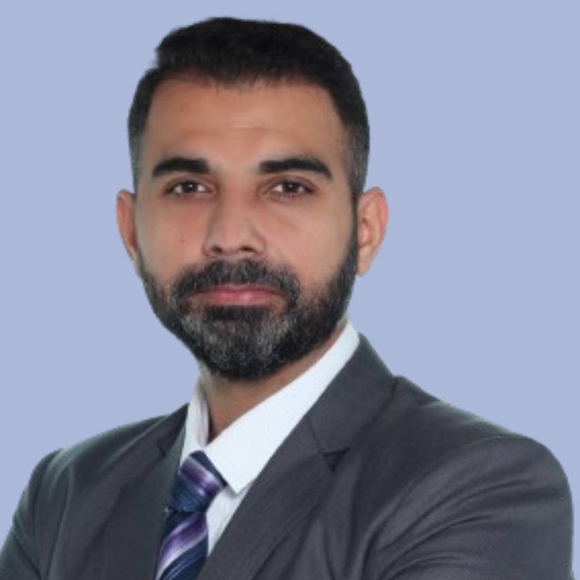 Varun Kalsi, a man with a beard and dark suit.