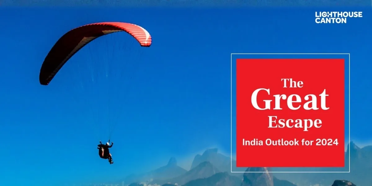 paraglider soaring against a blue sky and mountains logo CANTON.