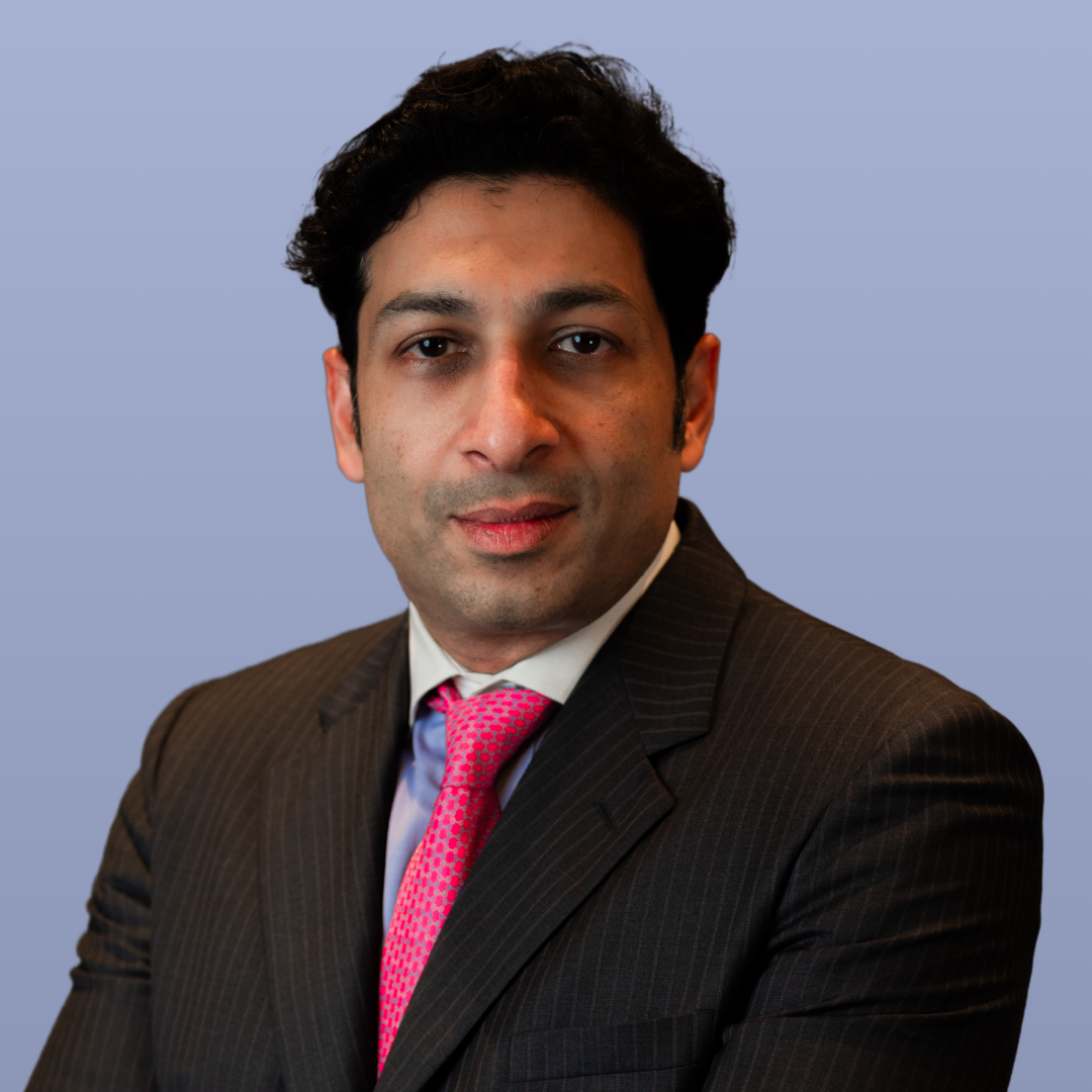 Ravi Kumar, a financial professional, is pictured in a dark pinstripe suit.