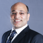 Rajesh Sharma, a financial advisor at Lighthouse Canton, smiles in a professional headshot.