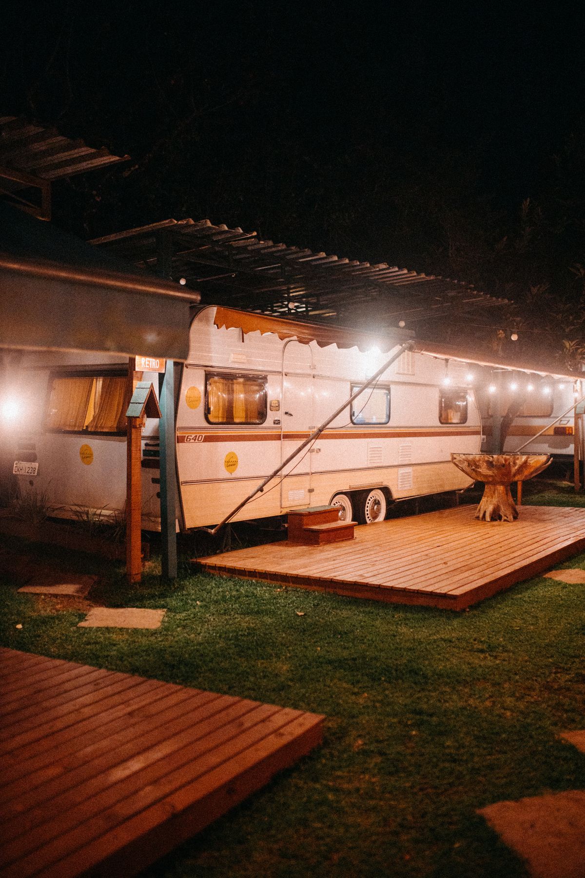 Camper übernachtet nachts auf einem beleuchteten Platz