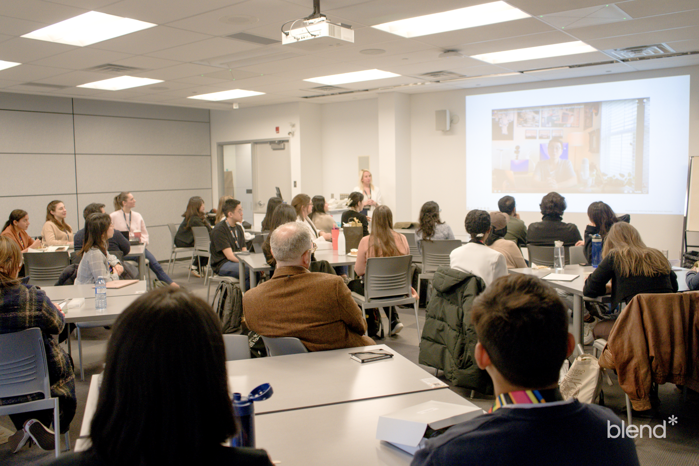 Backview of BLEND attendee audience watching a BLEND presenter