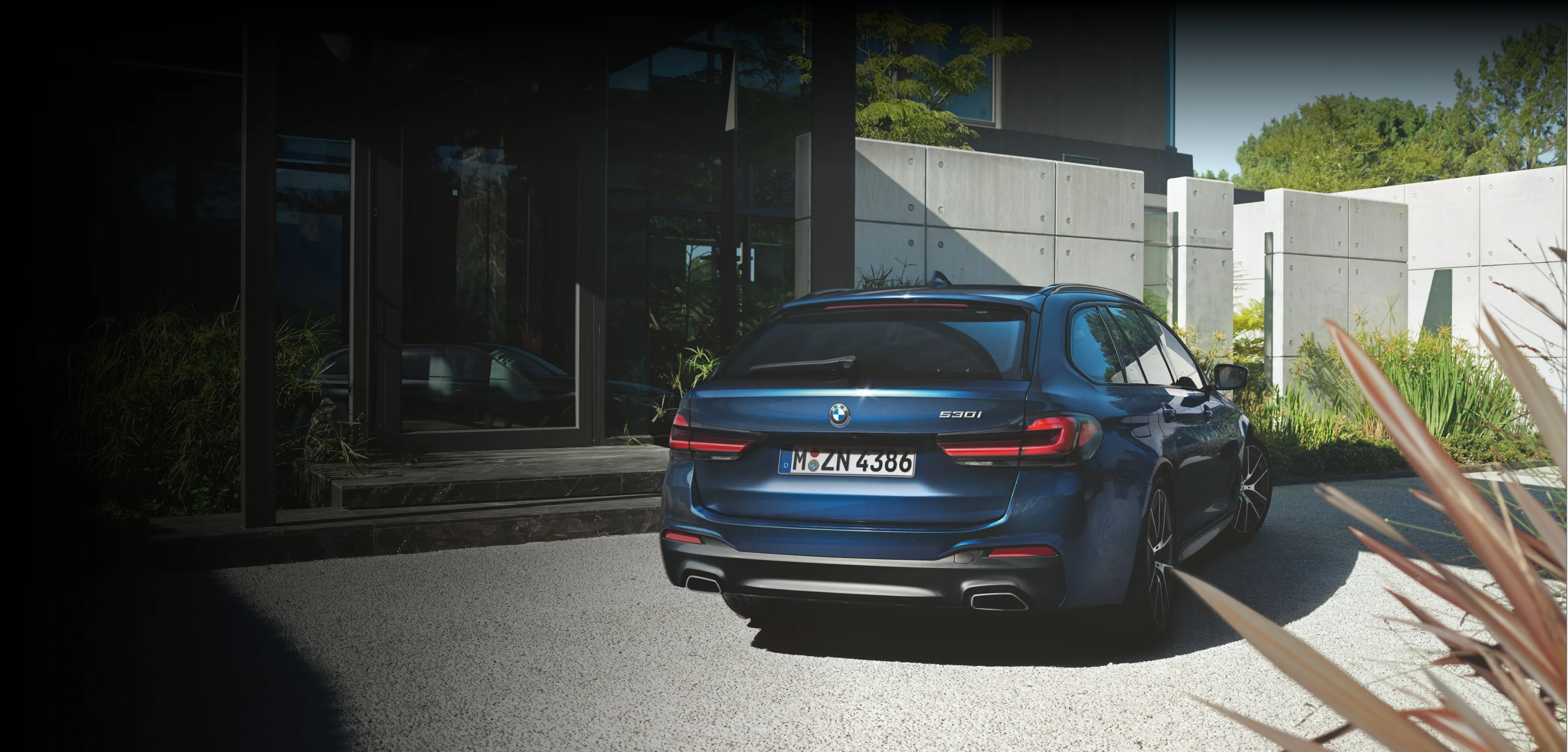 Website home page image, depicting a metallic blue BMW 530i car
