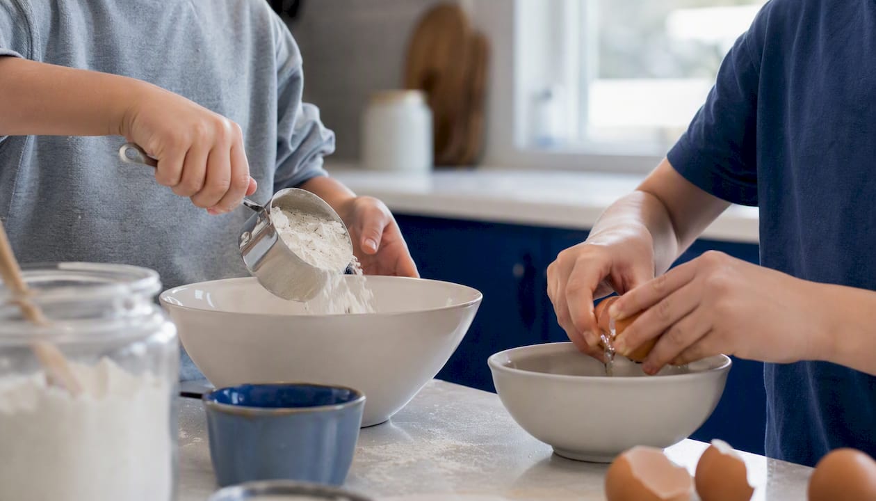 Children performing safe cooking tasks