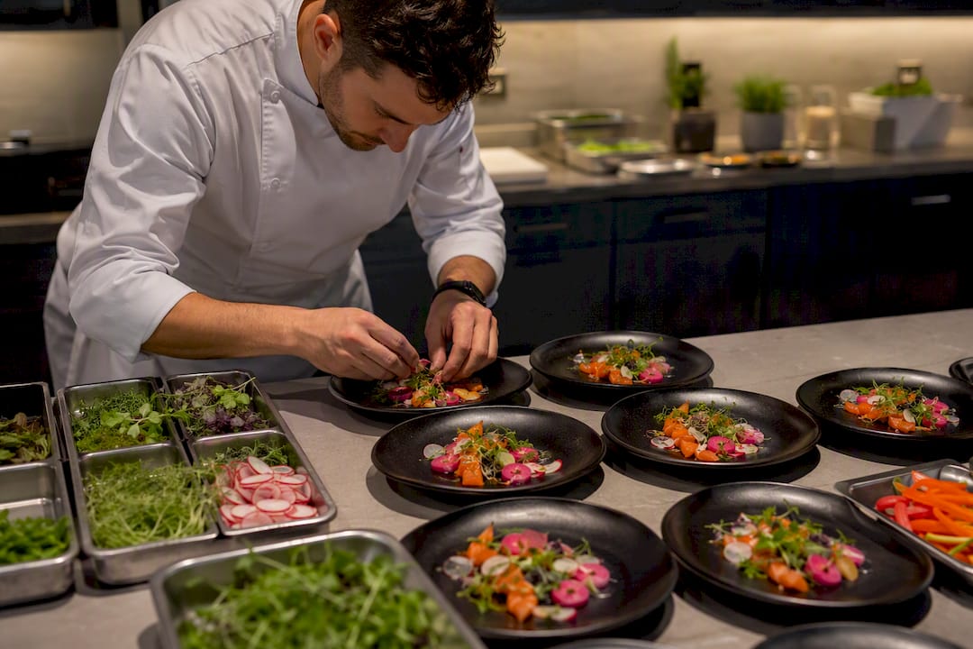 Chef plating dishes at professional catered event