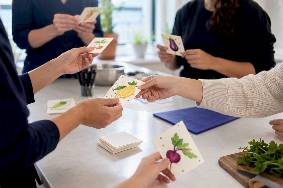 Hands exchanging colorful cards in icebreaker