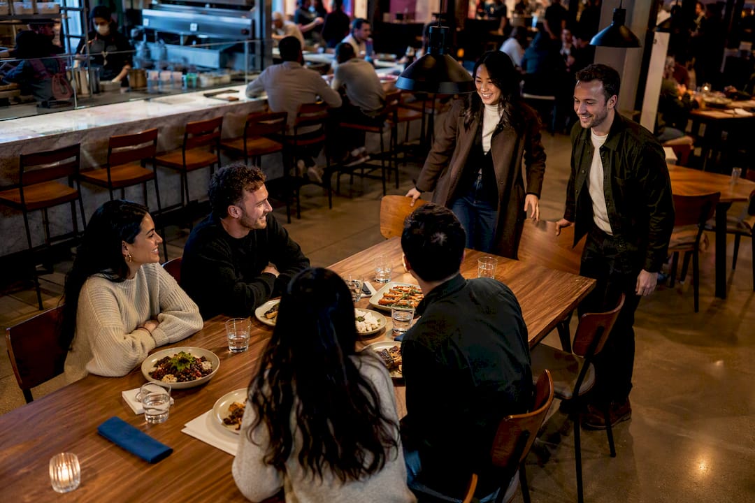 Friends sharing food at a communal food hall