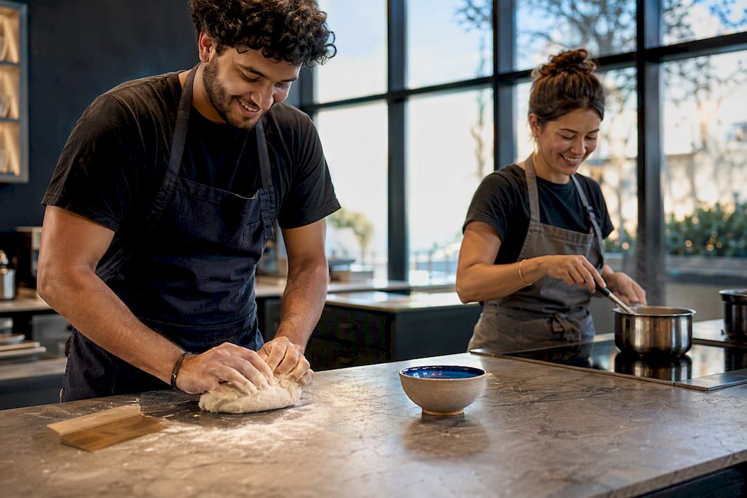 Couple handling separate cooking tasks