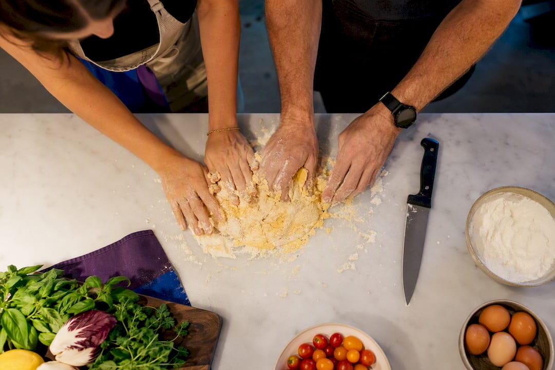 Couple kneading pasta dough together