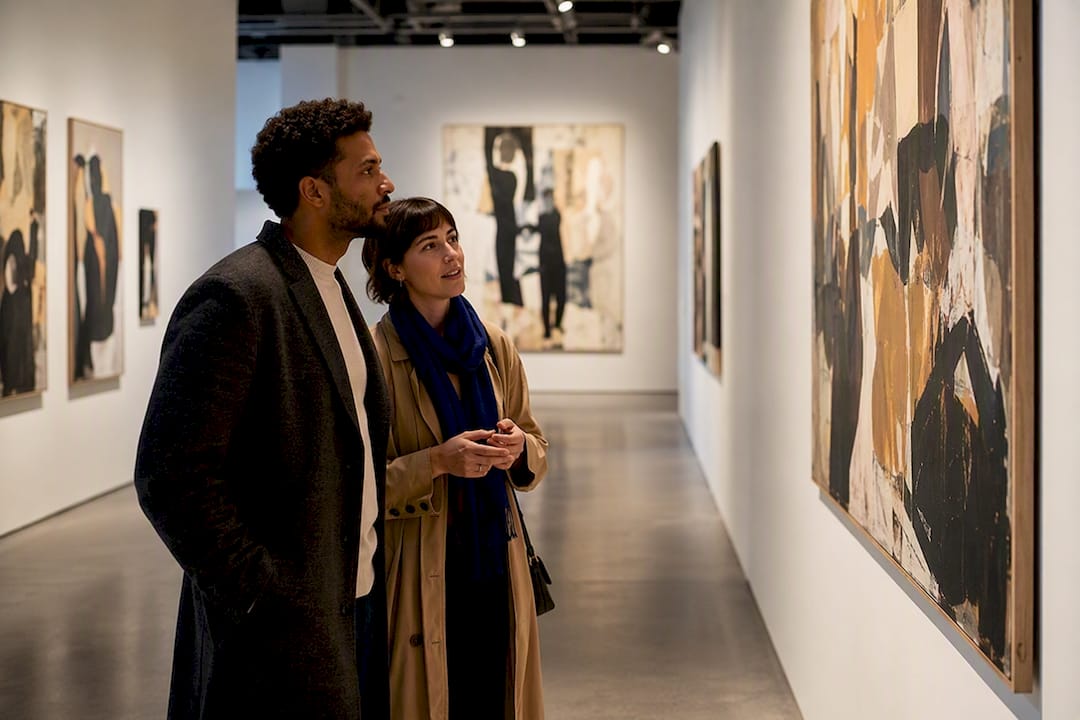 Couple viewing art in museum gallery