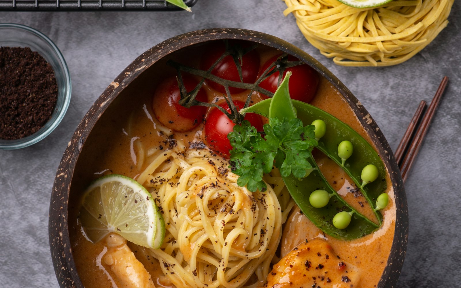 Bowl of Thai noodle curry with lime and fresh herbs from a cooking class near West Hollywood
