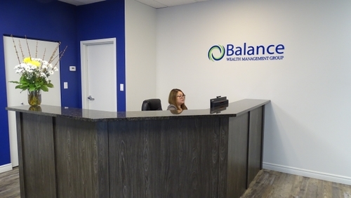 Angelia working at the front desk ready to assist clients