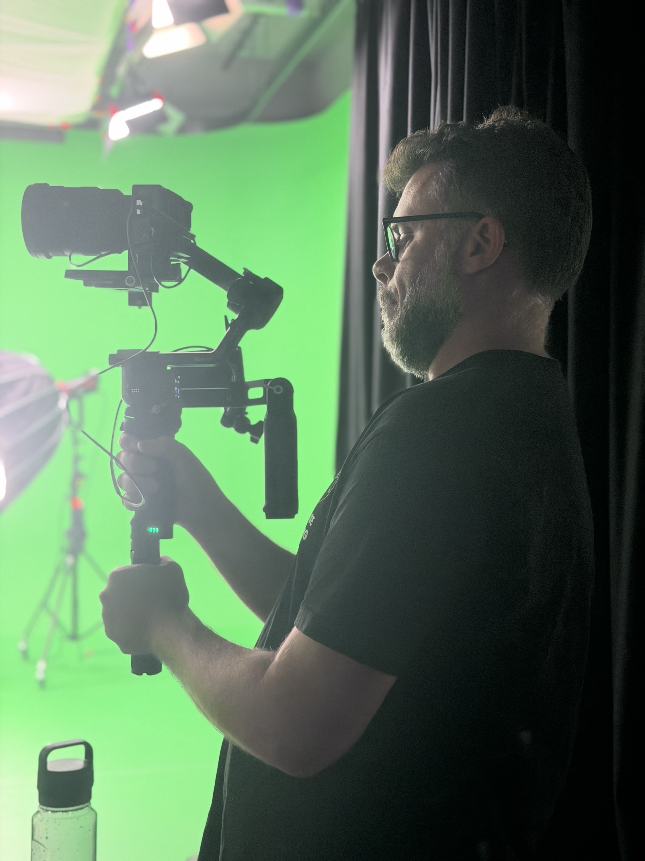 Camera operator with a gimbal rig on the green screen set