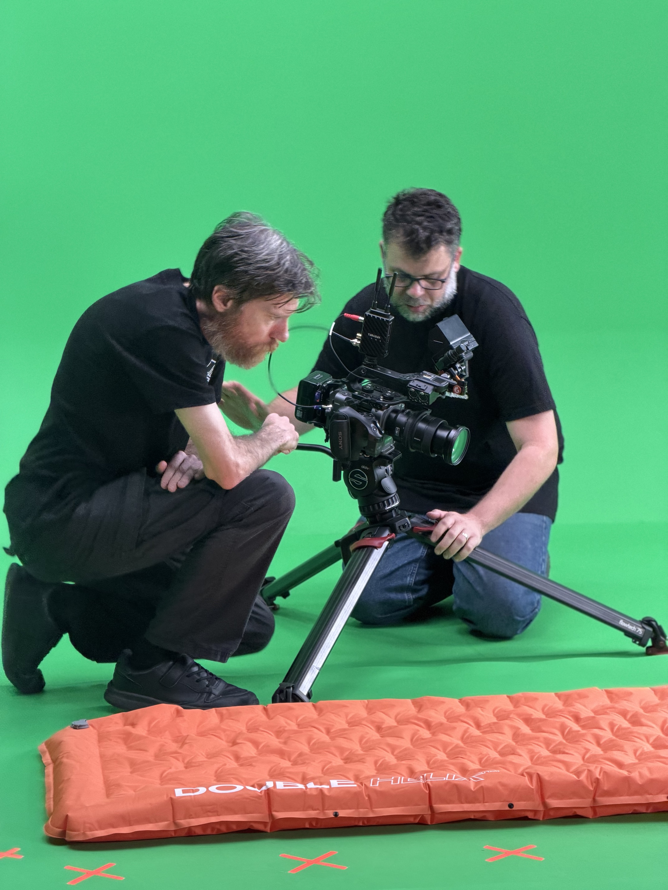 Crew filming a Barkers Rocks mat low on the green screen floor