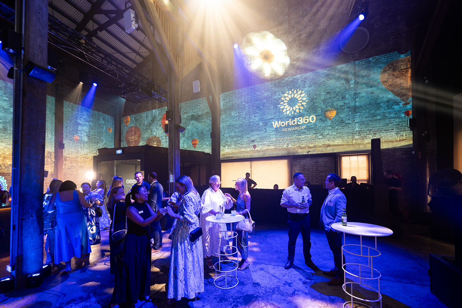 Guests mingling under World360 projections at the launch