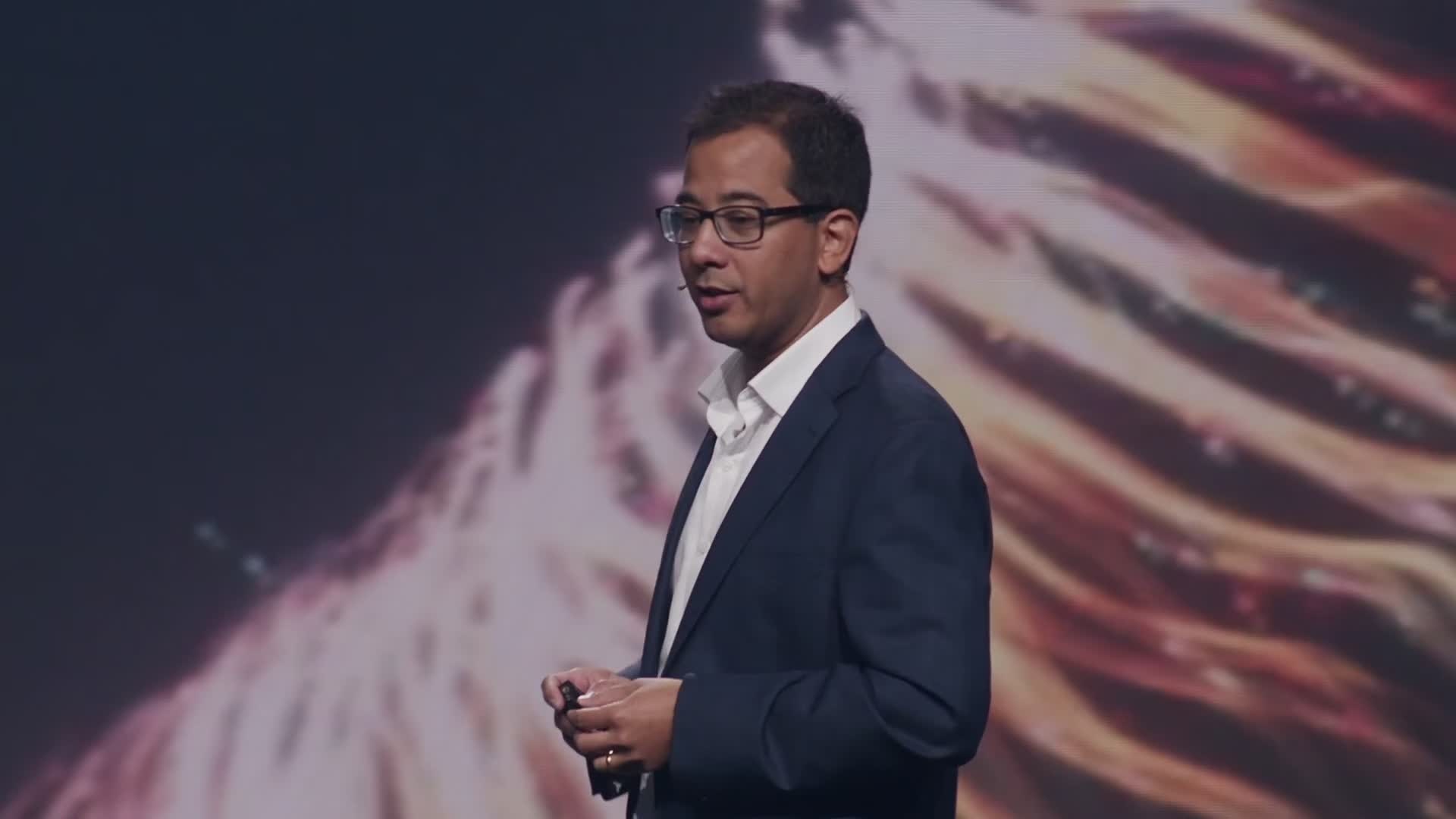 Close shot of a presenter in front of the LED screens
