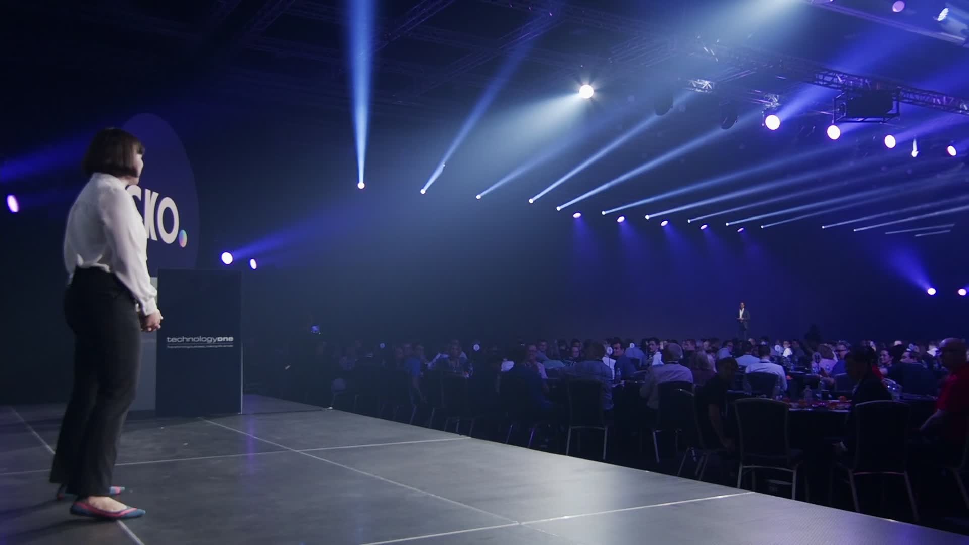 Presenter on the stage runway in front of the audience