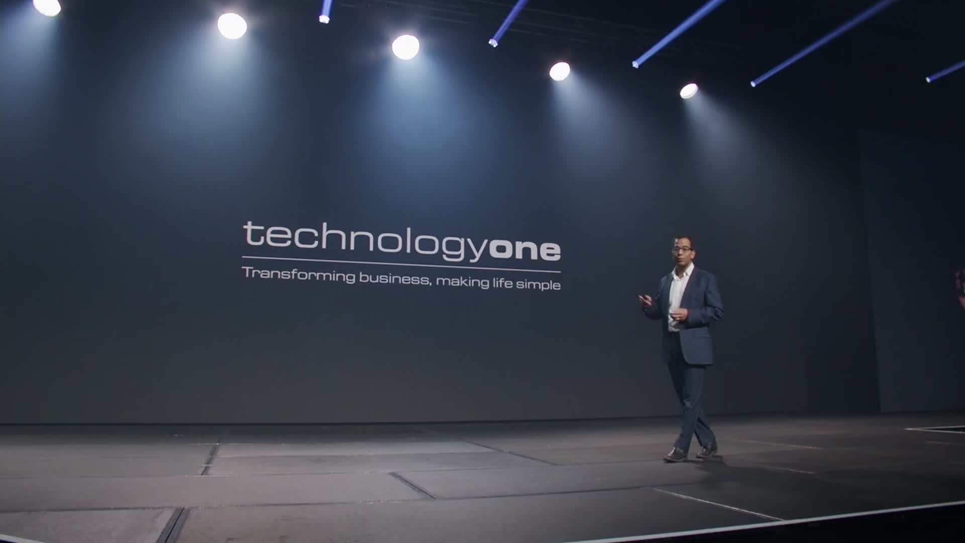 Presenter on the TechnologyOne stage with the LED backdrop