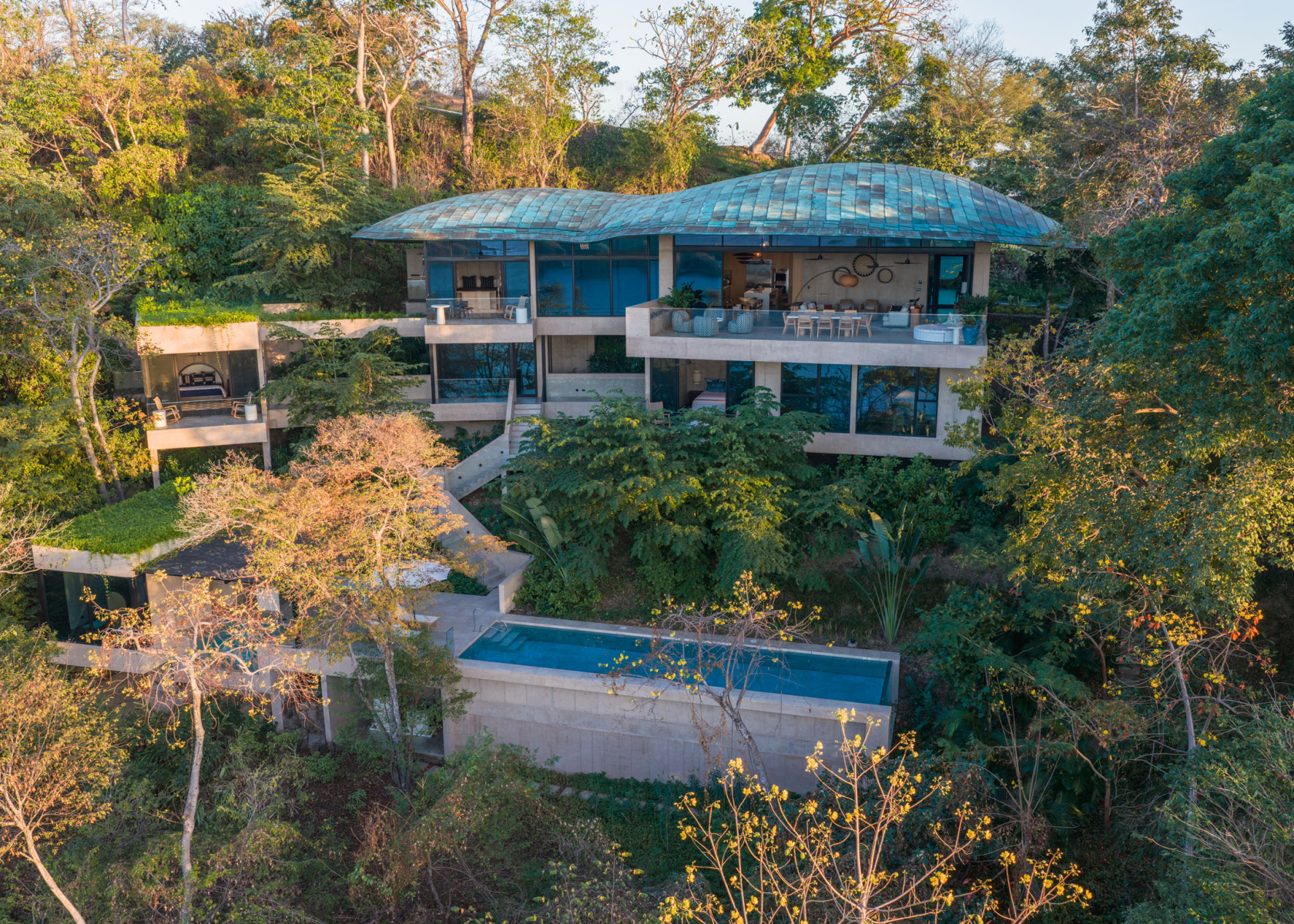 Cliffside home nestled in tropical forest