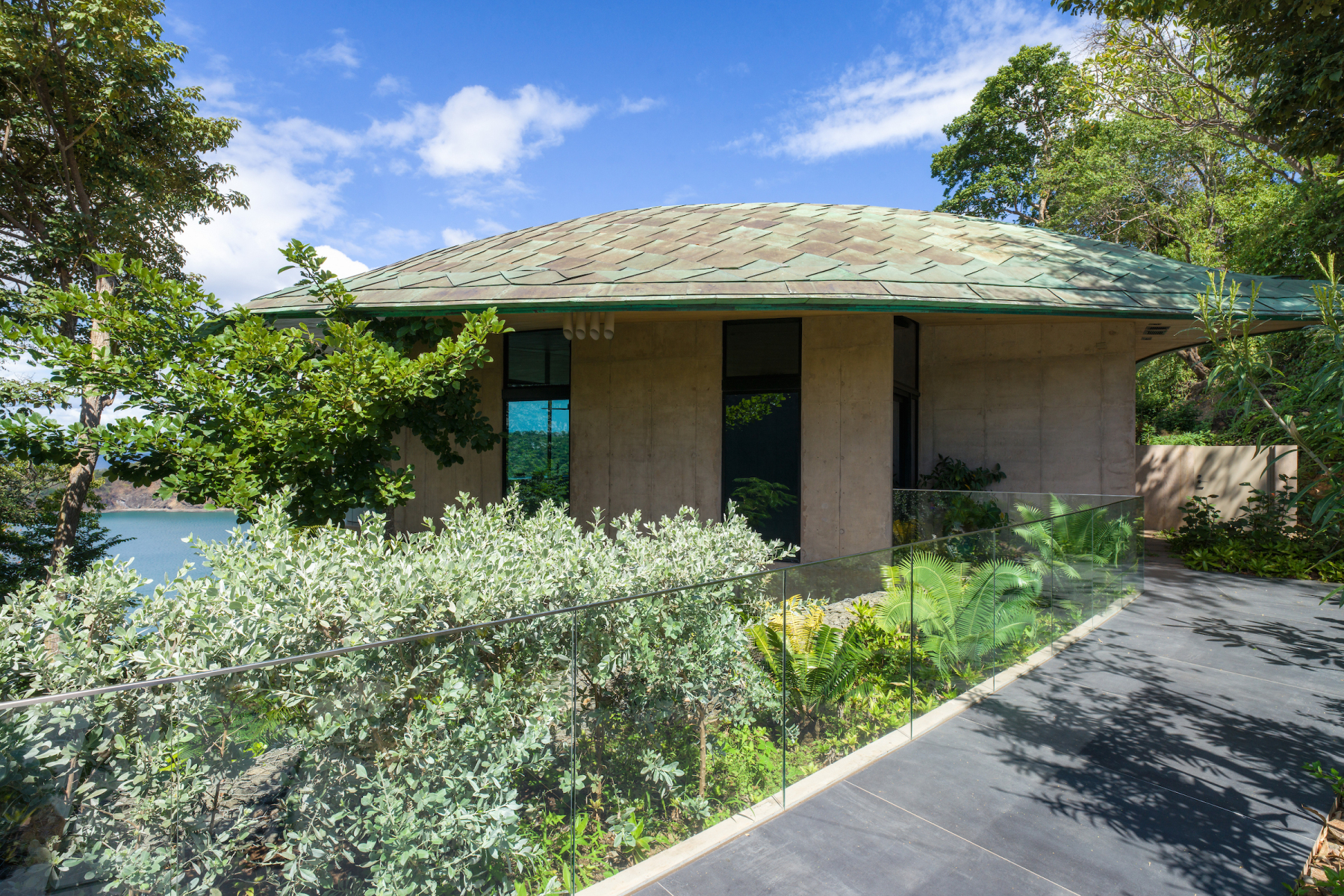 Stone entrance pavilion surrounded by tropical planting