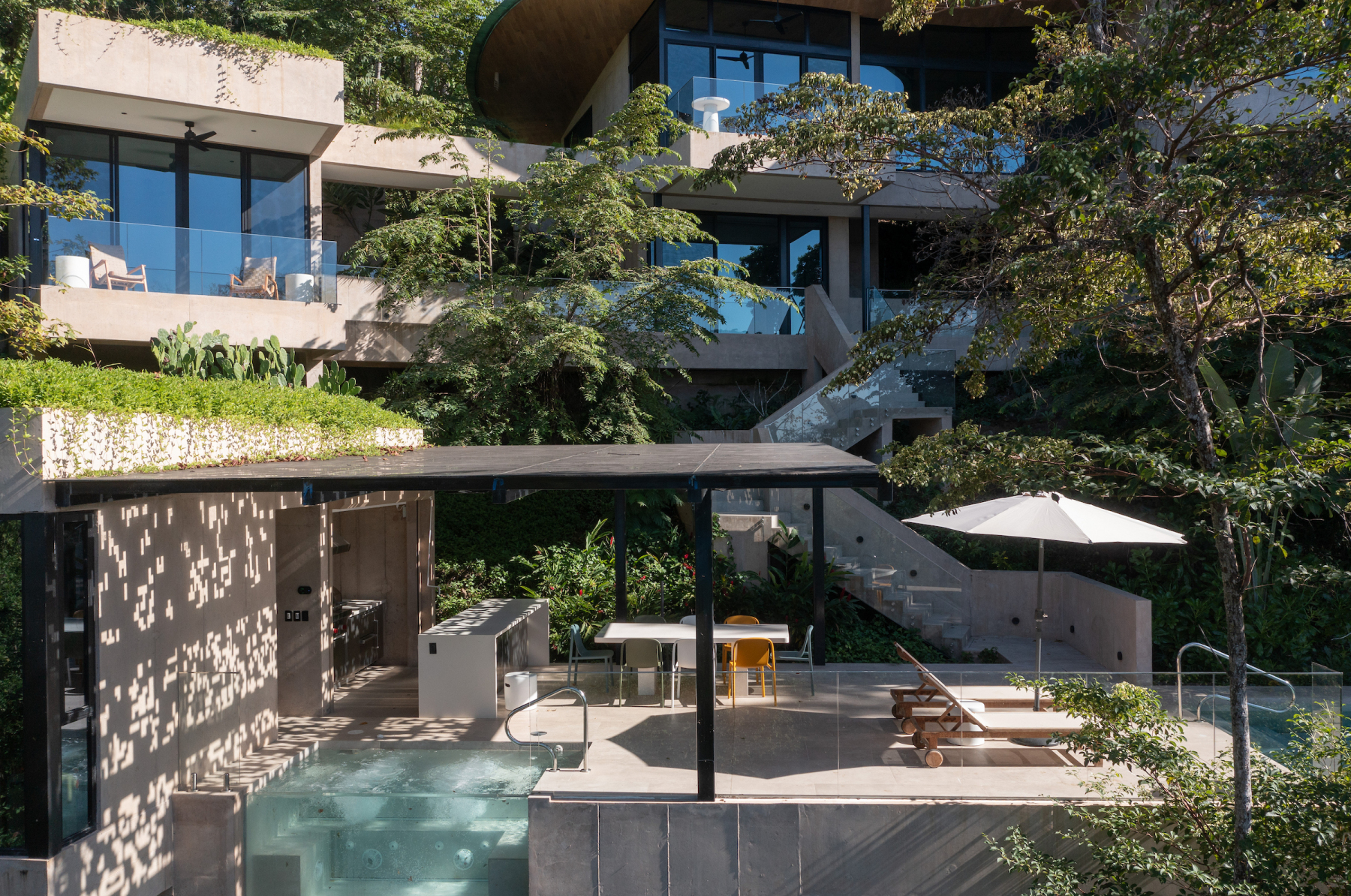 Terraced house with pool and shaded outdoor seating