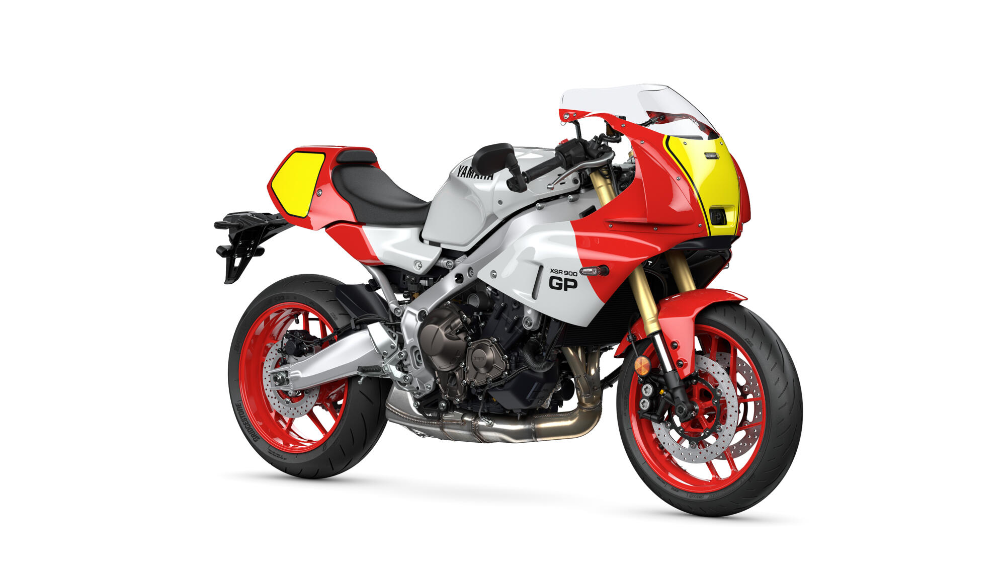 Red, white, and yellow Yamaha XSR900 GP motorcycle with red wheels and a racing-style fairing on a white background.