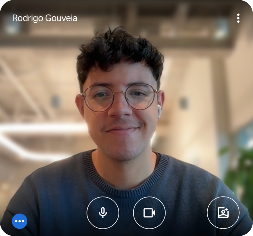 A picture of Rodrigo Gouveia standing on a bridge and holding a photography camera in front of his right eye