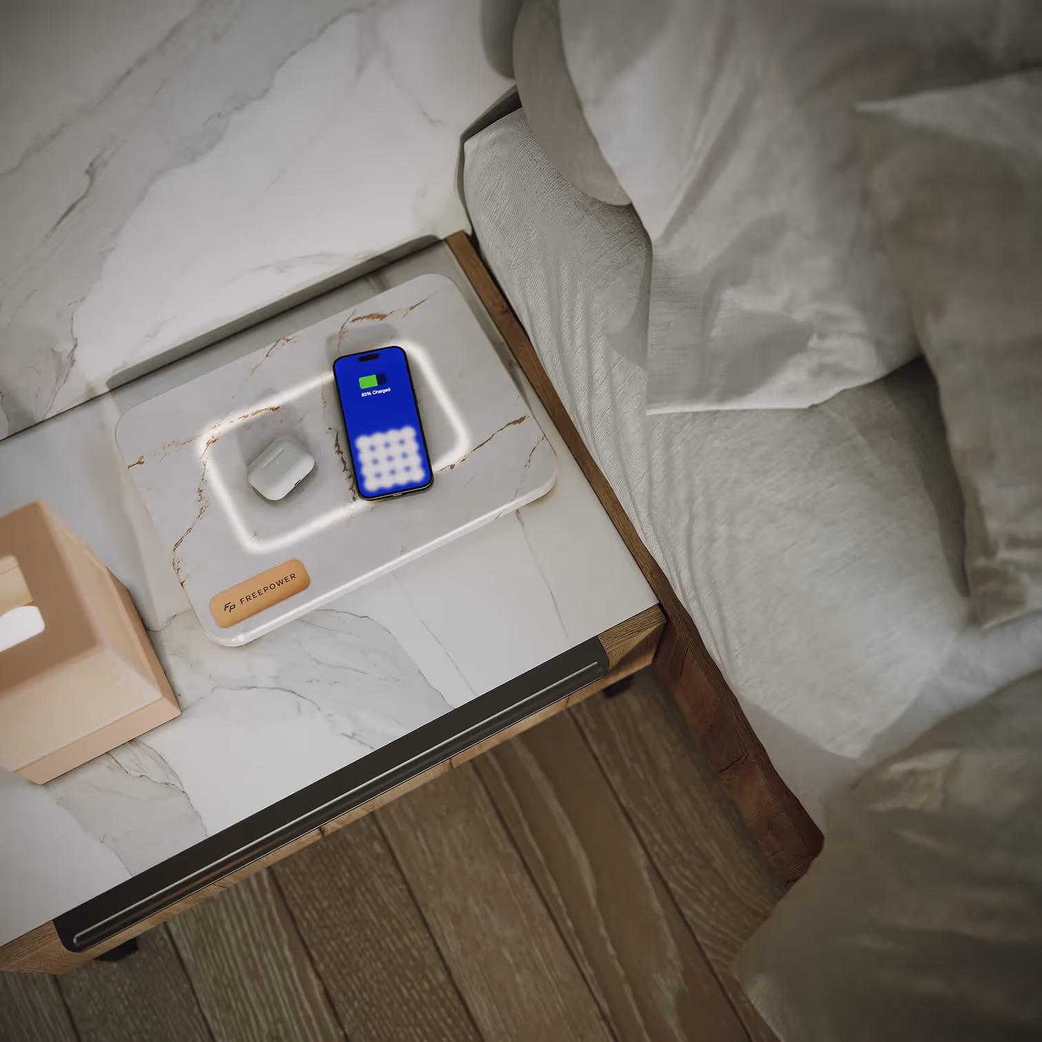 FreePower Valet -Wireless charging device on a bedside table charging a smartphone and wireless earbuds case.