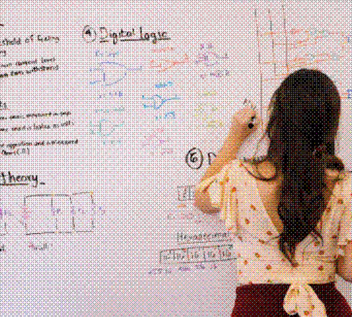 Person with long hair writing colorful digital logic notes and diagrams on a whiteboard.