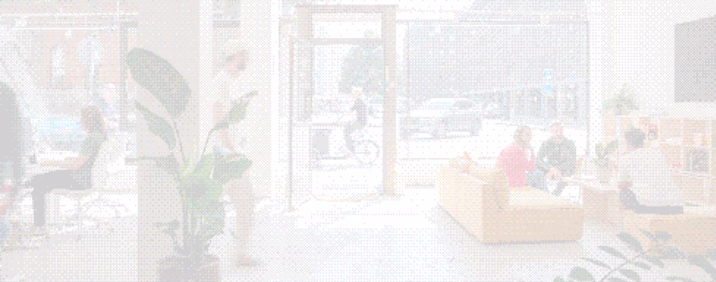 Modern office space with people working, meeting on sofas and using computers near a large glass door.