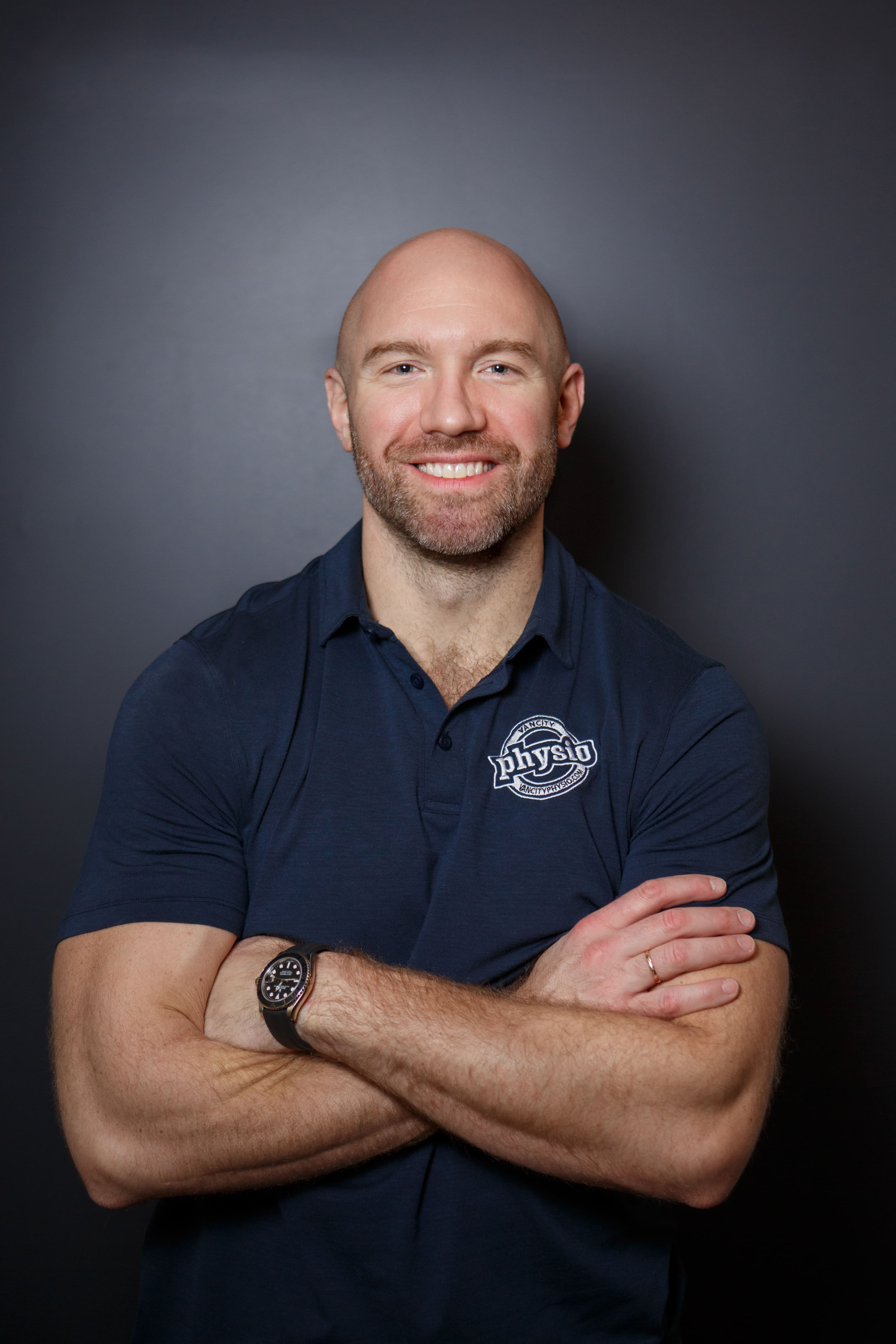 Ranko Vukovic, founder of VanCity Physio, smiling with arms crossed