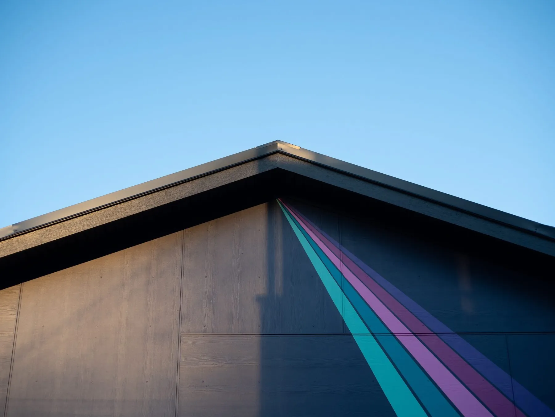 Laneway home roofline with a painted rainbow stripe by Smallworks