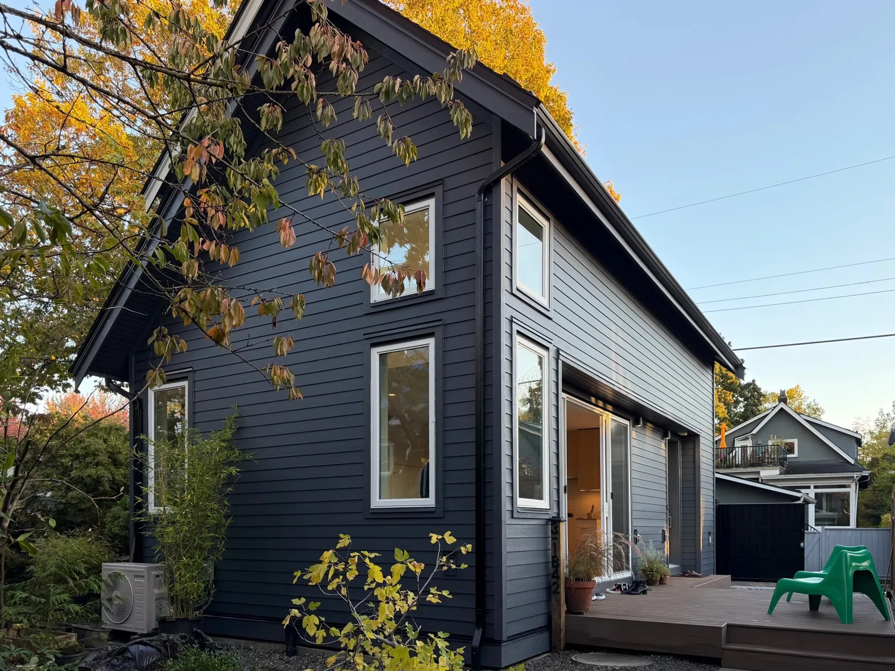 Navy laneway home with a garden deck by Smallworks