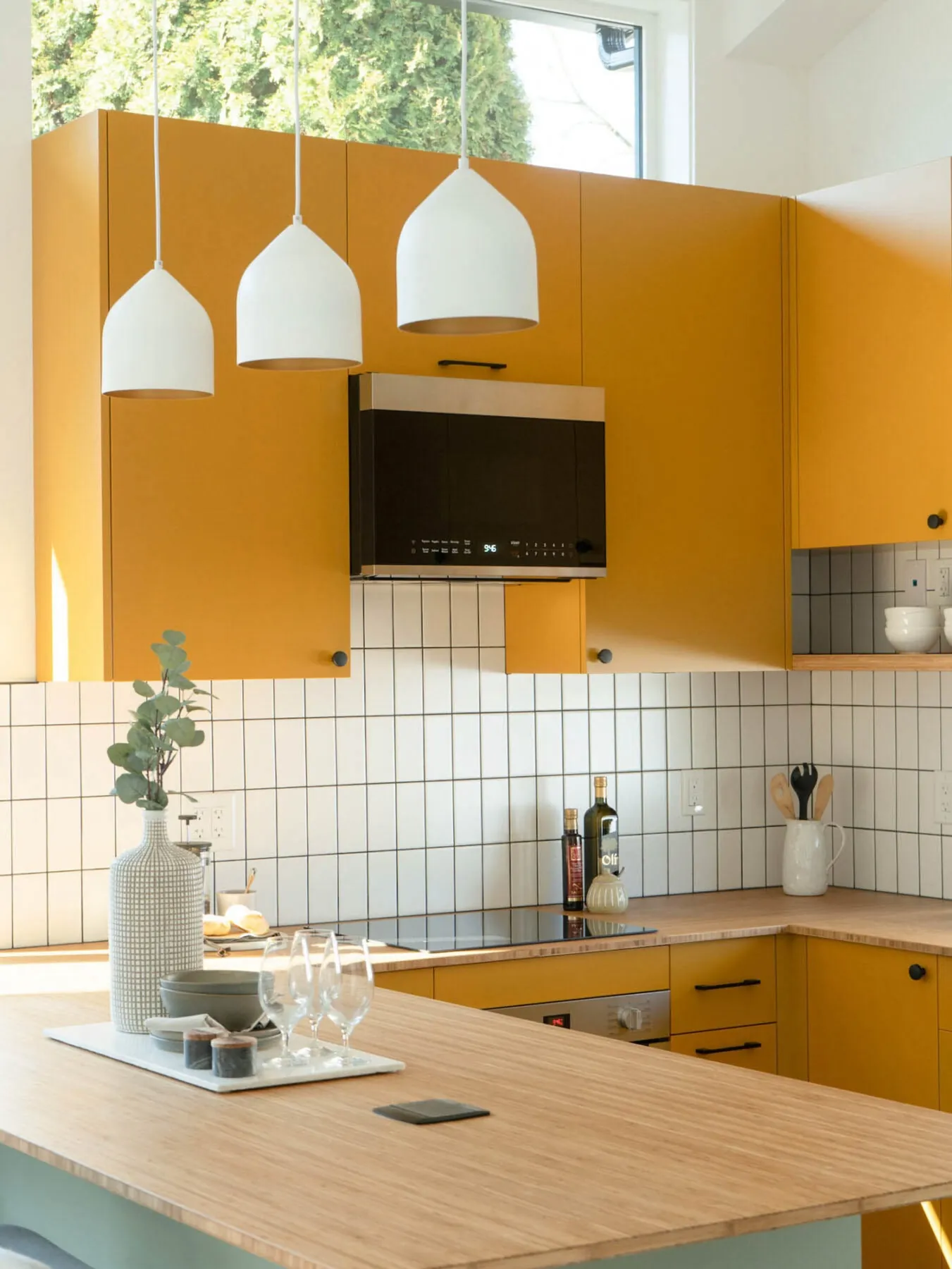 Yellow kitchen with pendant lights inside a Smallworks laneway home