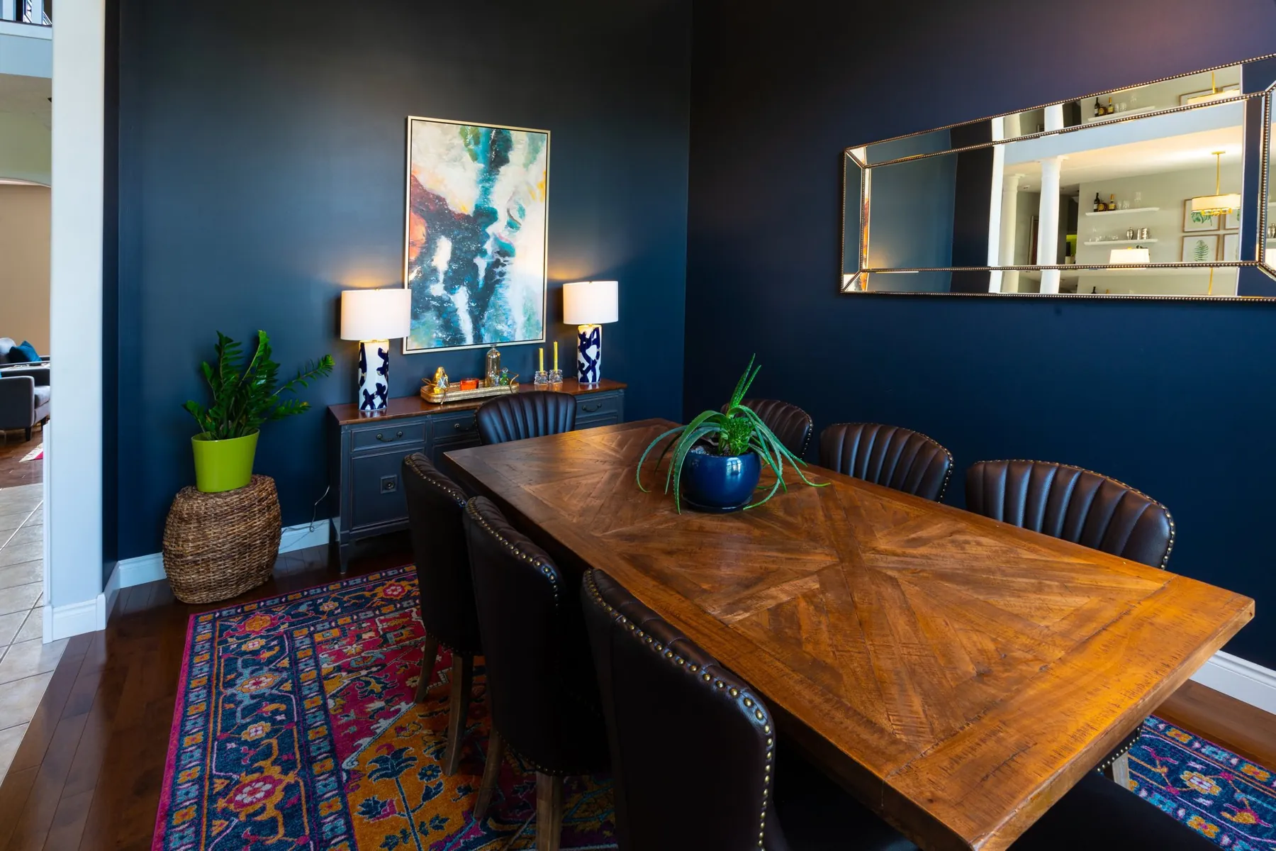 Navy dining room with a wood table designed by White Dahlia Design