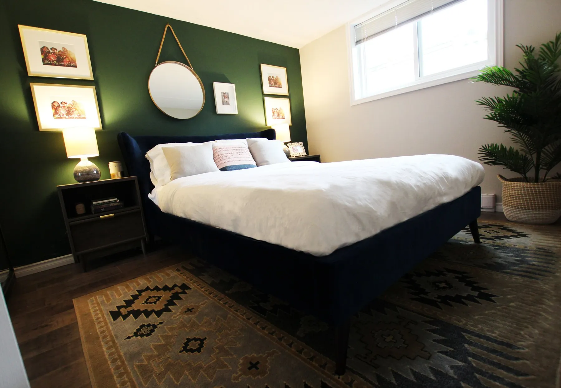 Dark green bedroom with a navy bed by White Dahlia Design