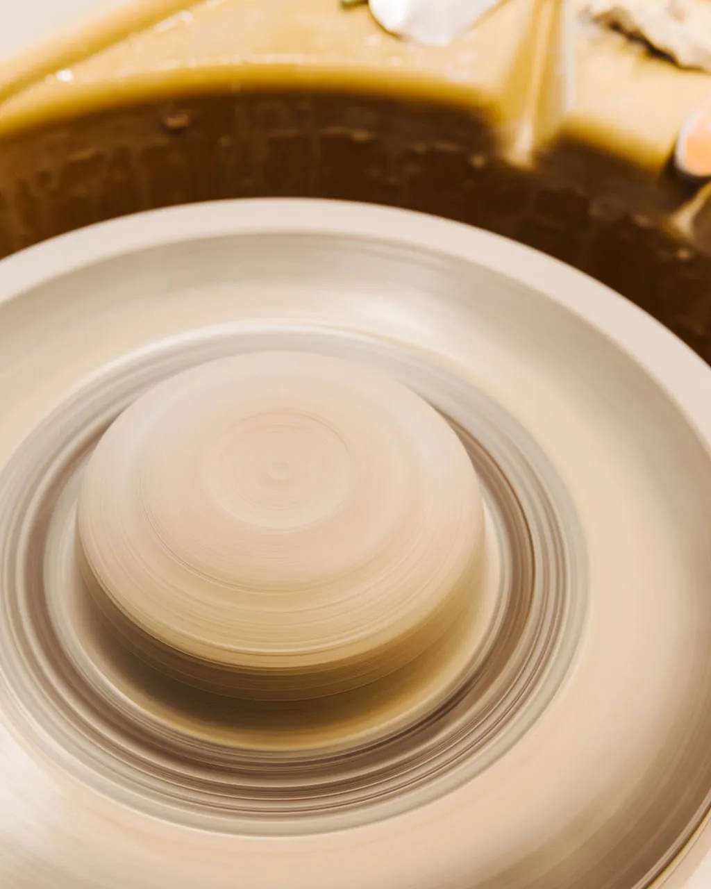 Spinning clay on a wheel at Hand Eye Ceramics